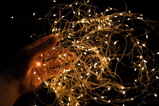 istock Beautiful shiny garlands in mans hands. 1480078188
