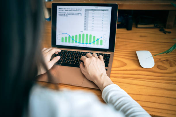 istock A Asian woman is working on online chart data processing in her home office or informal workspace. 1480081366