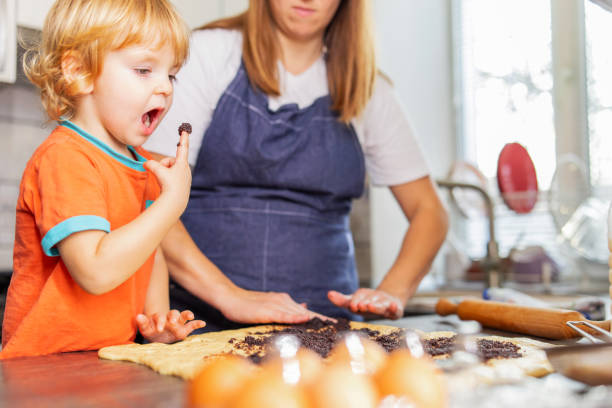 istock Mother and son boy making cookies and having fun in the kitchen 1480084130