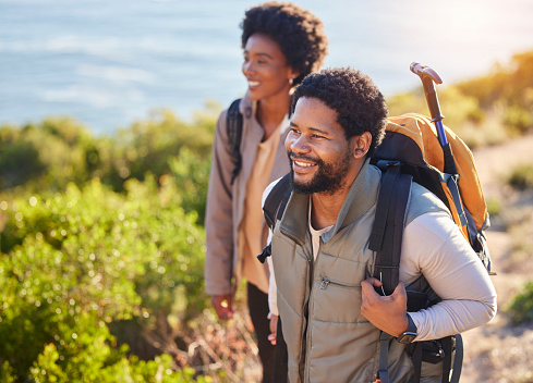 Mountain, happy or couple of friends hiking in nature for exercise, workout or training on summer holiday. Travel, black woman and African partner trekking or walking to hill on outdoor adventure