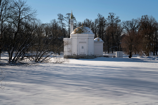 The pavilion of the Turkish Bath on the shore of a Large pond in the Catherine Park of Tsarskoye Selo on a sunny winter day, Pushkin, St. Petersburg, Russia