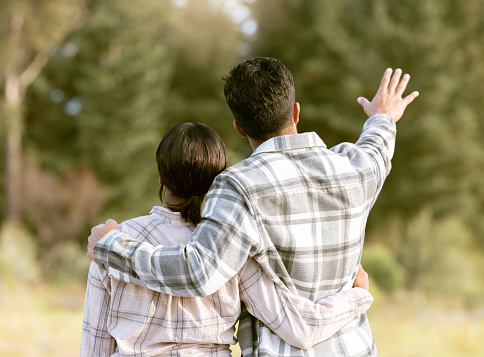 Trees, nature gesture and couple hug on outdoor quality time together, hiking adventure or forest bonding journey. Peace, freedom and love for back of travel woman, man or people trekking in woods