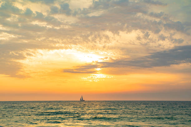 istock Distant Sailboat on the Ocean During Sunset 1480092582