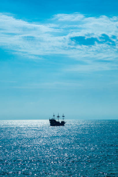 istock Pirate Ship Silhouette on the Ocean Horizon 1480093836