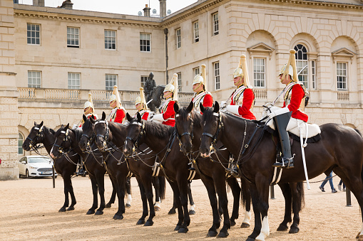 British guards in bearskin hats and red uniforms on parade in London, UK. Changing the guard takes place several times each week and is a very popular tourist destination