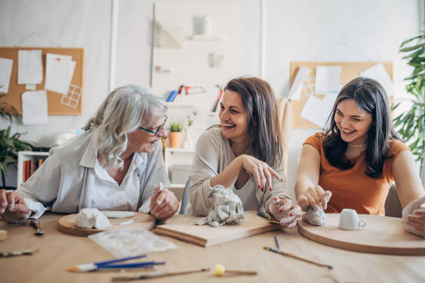istock Female siblings molding clay together 1480096811