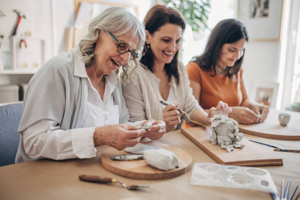 istock Female siblings molding clay together 1480097075