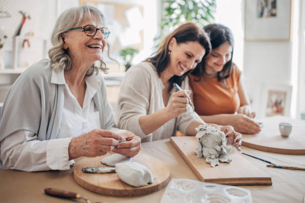 istock Female siblings molding clay together 1480097109