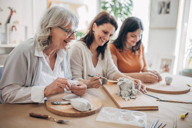 istock Female siblings molding clay together 1480097247