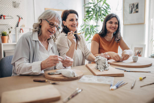 istock Female siblings molding clay together 1480097275