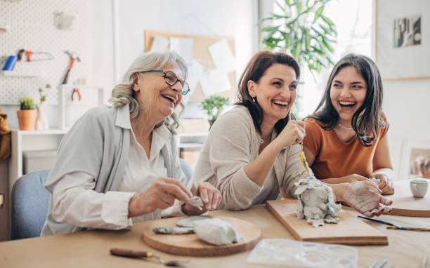 istock Female siblings molding clay together 1480097301