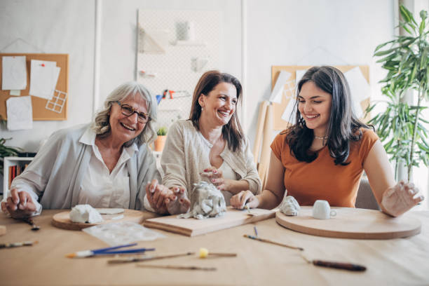 istock Female siblings molding clay together 1480097333