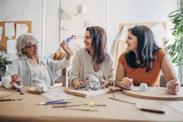 istock Female siblings molding clay together 1480097368