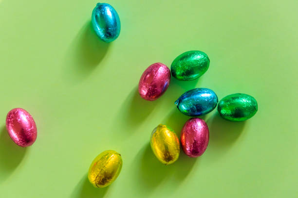istock Easter chocolate eggs in foil on green background. Top view 1480097374