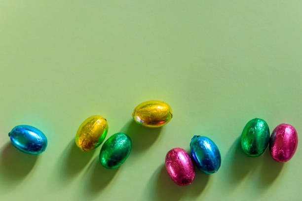 istock Easter chocolate eggs in foil on green background. Top view 1480097377