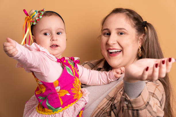 istock baby girl and mom to Brazilian Festa Junina calling and inviting 1480098277