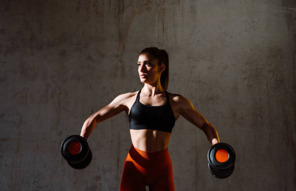 istock Young female athlete training in a gym using sport equipment 1480101063