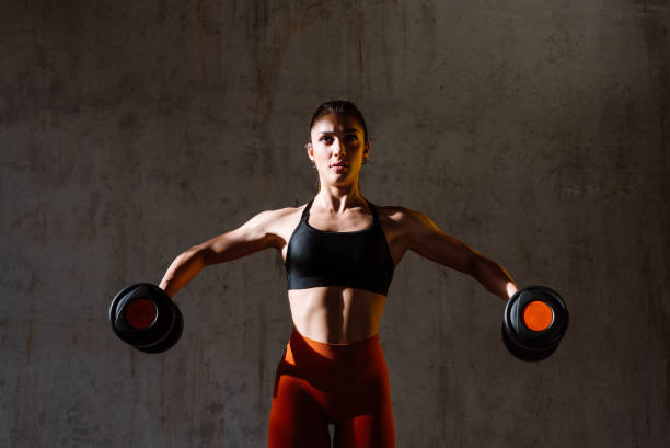 istock Young female athlete training in a gym using sport equipment 1480101391