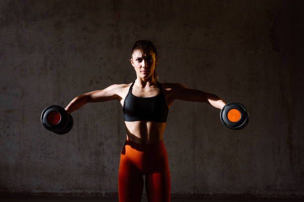 istock Young female athlete training in a gym using sport equipment 1480102228