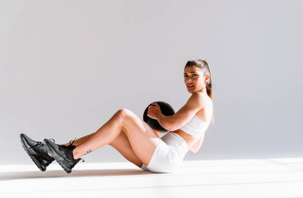 istock Young female athlete training in a gym using sport equipment 1480102661