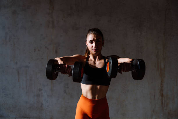 istock Young female athlete training in a gym using sport equipment 1480102930