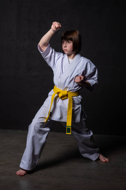 istock A karate girl trains in a kimono with punches and kicks 1480103096