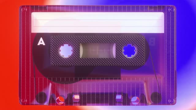 Rotating tape on an old vintage cassette. Retro music concept. Radio tape recorder, audio cassette. Vintage neon lighting