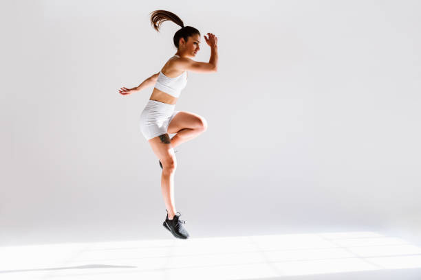 istock Young female athlete training in a gym using sport equipment 1480103319