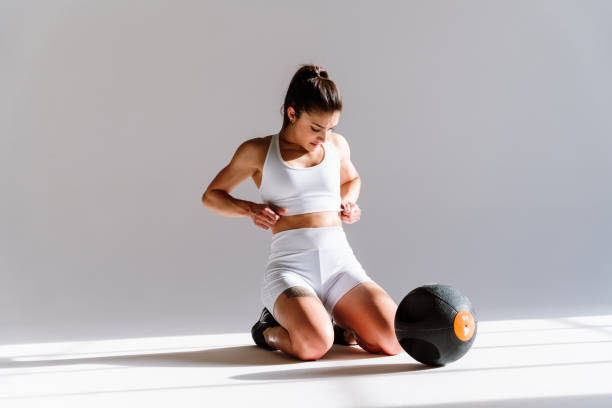 istock Young female athlete training in a gym using sport equipment 1480103761