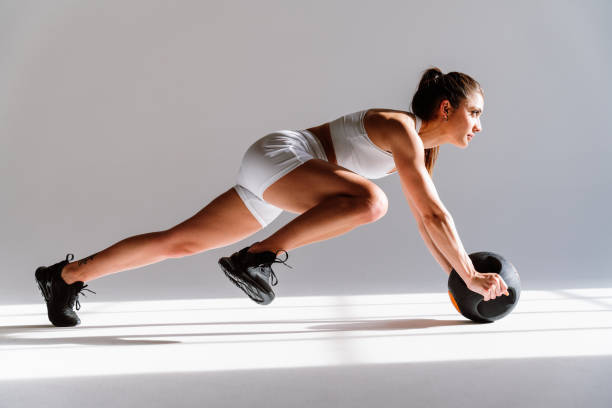 istock Young female athlete training in a gym using sport equipment 1480103965