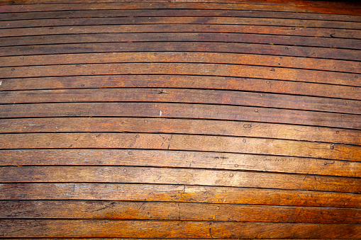 Texture of old wooden surface. Side of the hull of an old wooden ship.
