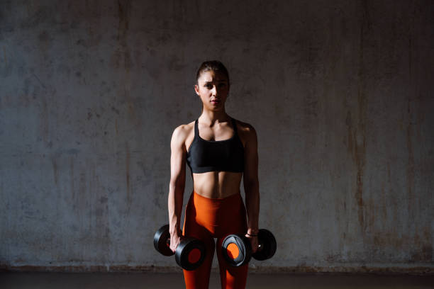 istock Young female athlete training in a gym using sport equipment 1480105314