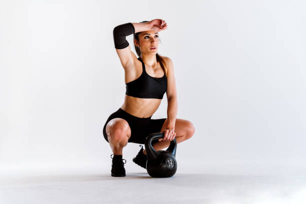 istock Young female athlete training in a gym using sport equipment 1480105344