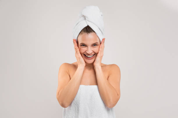 istock Bath Fun. Cheerful Middle Aged Woman Wrapped In Towel Over Light Background 1480106728