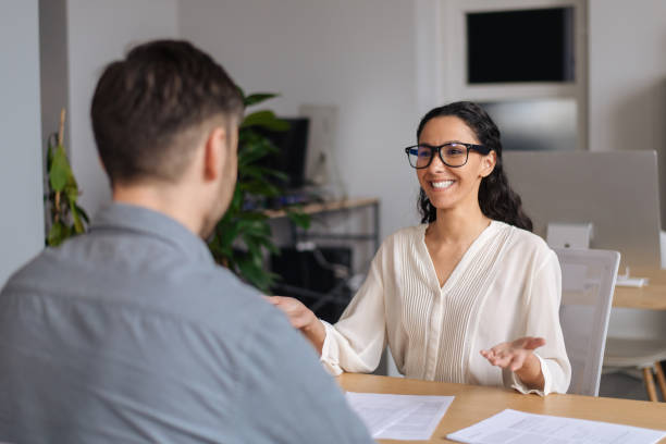 istock Positive hiring manager speaking to vacancy candidate during employment interview at modern company office 1480107482