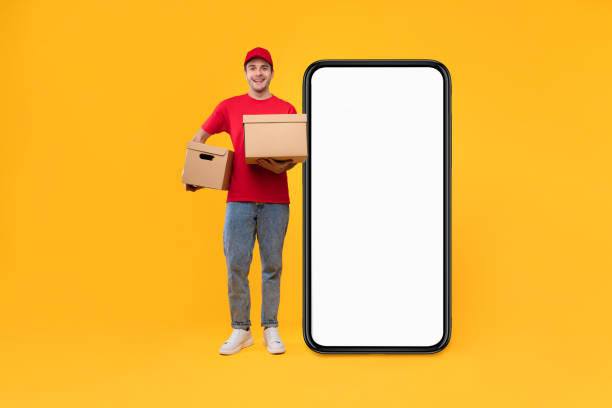 istock Courier Guy Near Huge Phone Screen Holding Boxes, Yellow Background 1480107750
