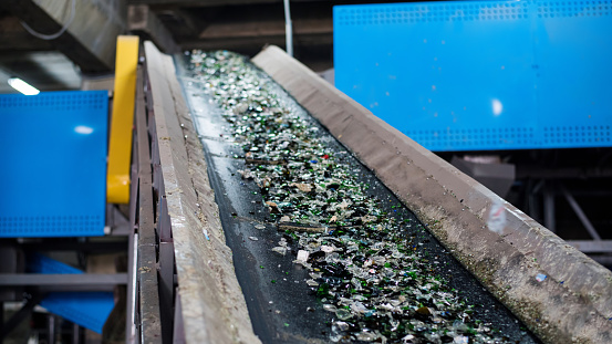 Process of sorting glass garbage on a vibrating conveyor belt at waste sorting plant