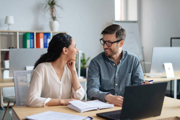 istock Teamwork and collaboration concept. Happy young coworkers having friendly communication at workplace 1480108006