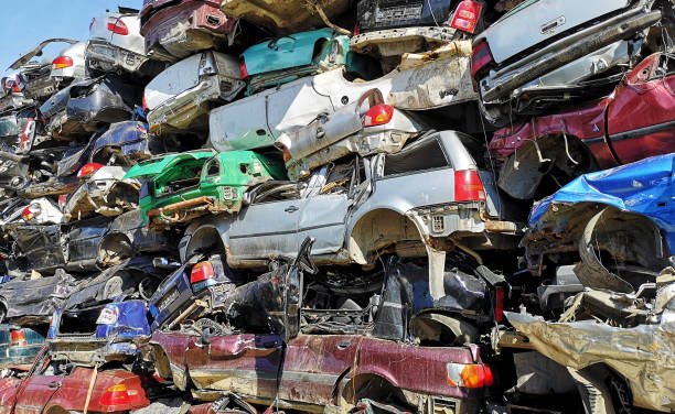 Stacked crushed cars in scrap yard stock photo