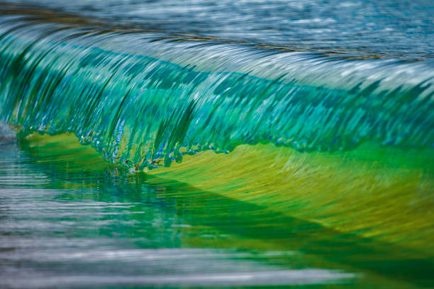 Miniature macro wave breaking on shoreline with stunning detail. Abstract ocean theme.