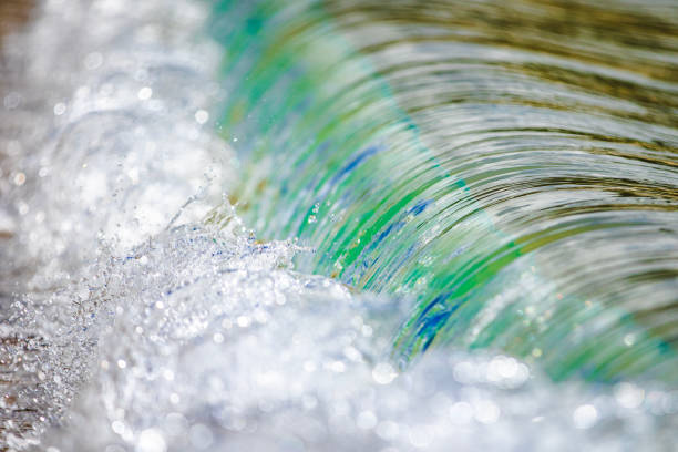 Miniature macro wave breaking on shoreline with stunning detail. Abstract ocean theme.