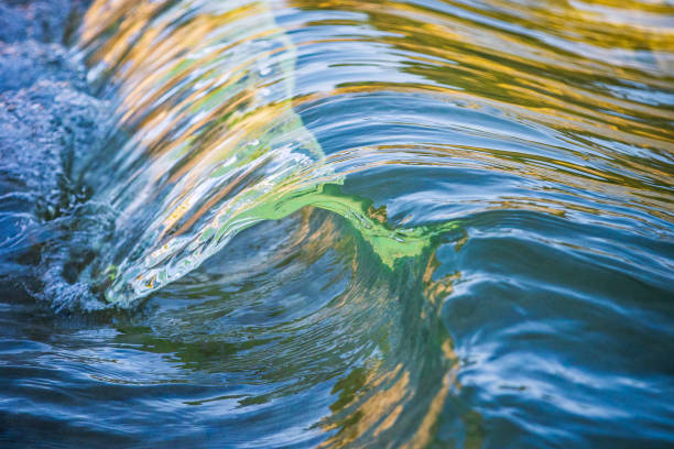 Miniature macro wave breaking on shoreline with stunning detail. Abstract ocean theme.