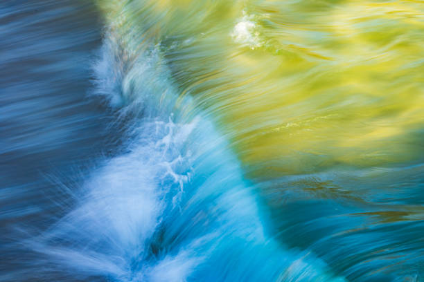 Abstract long exposure of wave breaking on sandy shoreline.