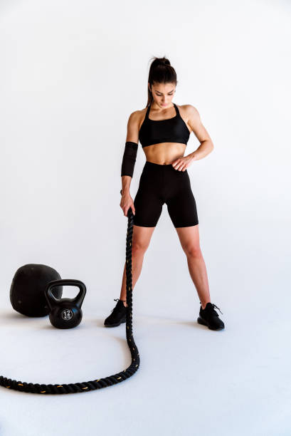 istock Young female athlete training in a gym using sport equipment 1480111663