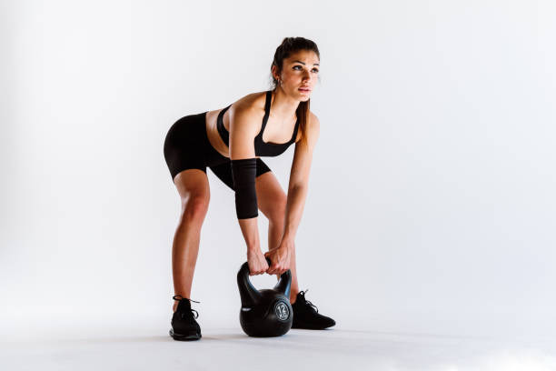 istock Young female athlete training in a gym using sport equipment 1480113954