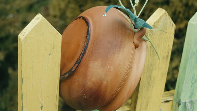 Clay pots hanging on the fence