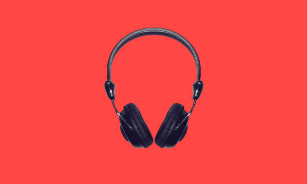 istock Black wireless headphones isolated on red background, top view 1480118466