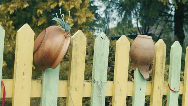 Clay pots hanging on the fence