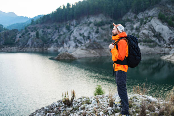 istock Male backpacker hiking in mountains 1480120547