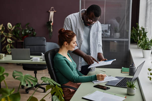 istock Side view two people discussing project in office decorated with plants 1480123054